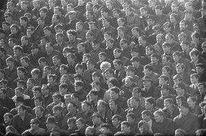 100 men and one woman in a stadium, 1973